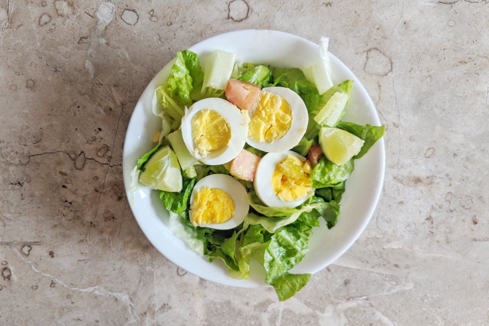 Fresh Vegetable Salad with Boiled Eggs on White Ceramic Plate