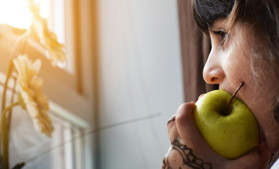 woman biting apple